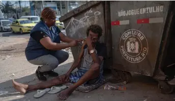  ?? — AFP photos ?? Nurse Assistant Sandra Maria (left) gives a Covid-19 vaccine to a homeless man in the suburbs of Rio de Janeiro, Brazil.