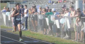  ?? STAFF PHOTO BY TED BLACK ?? La Plata High School’s Gage White completes the three-mile course on his home track on Wednesday but settles for second behind Leonardtow­n High School junior Parker McDowell who led the Raiders to a sweep of the dual meet by finishing nearly 21 seconds...