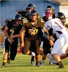  ?? BEN MADRID ENTERPRISE-LEADER ?? Connor West, jersey No. 50, shown competing against Morrilton, made the play of the game on Friday by scooping up a fumble and returning the football 66 yards for the game-winning touchdown with 24 seconds left. The Tigers prevailed, 35-28, by virture...