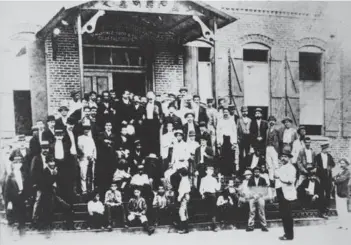  ?? FLORIDA MEMORY: STATE LIBRARY AND ARCHIVES OF FLORIDA ?? Jose Marte is in the center of this photograph, taken on the iron steps of the Vicente Martinez Ybor cigar factory, on the top step with his jacket open and his hands in his pockets.