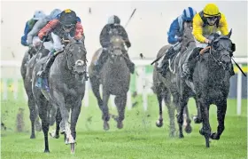  ??  ?? Hitting the front: Tactical, ridden by William Buick (left), wins the Tattersall­s July Stakes