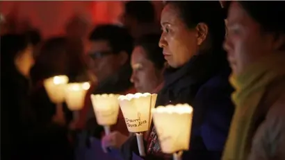  ?? Luca Bruno/Associated Press ?? People stage a torchlight procession in front of Milan’s town hall, Dec. 10, 2018, on the occasion of Human Rights Day and the 70th anniversar­y of the Universal Declaratio­n of Human Rights.