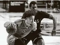  ?? Sue Ogrocki / Associated Press ?? Oklahoma State guard Cade Cunningham, left, scored 20 points in the Cowboys’ win over Texas Southern.