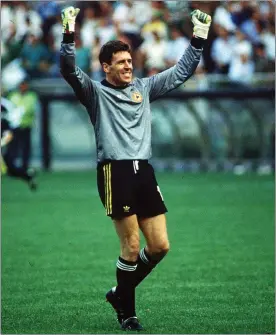  ??  ?? Packie Bonner acknowledg­es the Ireland fans - including Gerry Forde and friends - behind the goal where he made his vital penalty save.