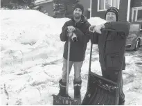  ?? DAVID MAHER/SALTWIRE NETWORK ?? Joe (left) and Dennis English take a breather after four days of digging on McGrath Crescent in Mount Pearl.