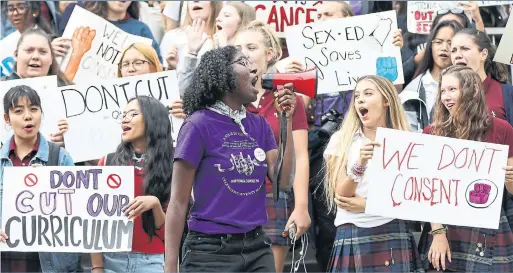  ?? RANDY RISLING TORONTO STAR ?? Notre Dame High School student Flora Nwakobi rallies schoolmate­s Thursday ahead of a day of action organized by Rayne Fisher-Quann, below.