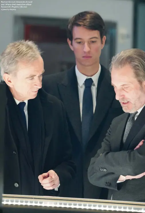  ??  ?? Bernard Arnault, Alexandre Arnault and Tiffany chief executive officer Alessandro Bogliolo talk over a jewelry display.