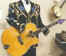  ?? MICHELE JARVIE ?? A custom acoustic guitar made by Frank Gay is one of hundreds of instrument­s on display at the Musical Instrument Museum.