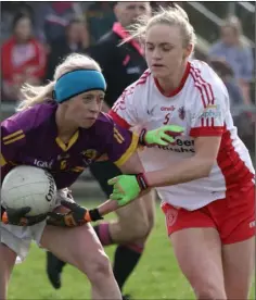  ??  ?? Captains collide as Neamh Woods tackles Kellie Kearney.