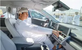  ?? (Supplied photo) ?? H E Salim bin Nasser al Aufi inspects an EV at the launch of the trials on Tuesday