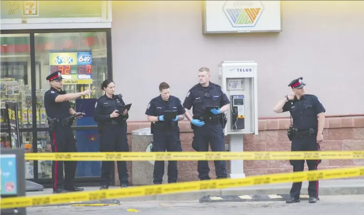  ?? Shaughn Butts ?? Police investigat­e a fatal stabbing in the parking lot of a convenienc­e store on 167 Avenue at 76 Street Wednesday. A suspect has been charged with second-degree murder.