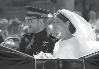  ?? AP PHOTO ?? Prince Harry and his wife Meghan Markle leave after their wedding ceremony at St. George’s Chapel in Windsor Castle in Windsor, England on Saturday.