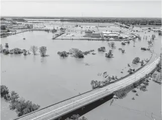  ?? REUTERS ?? Rising floodwater­s of the Tittabawas­see River are shown after the breach of two dams in Midland, Mich., on Wednesday.