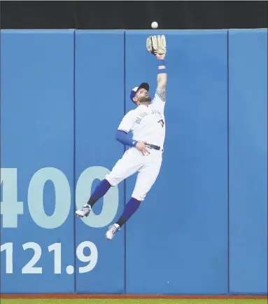  ?? Tom Szczerbows­ki / Getty Images ?? Toronto’s Kevin Pillar makes a leaping catch against the wall in the second inning.