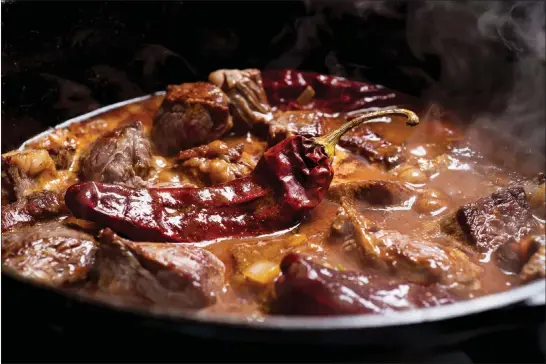  ?? PHOTOS BY KARSTEN MORAN / NEW YORK TIMES ?? A classic chili, the Texas bowl of red, is simply beef and hot peppers, simmered to perfection. But there’s no single recipe for the dish and no incorrect one. Below, a variety of ingredient­s appropriat­e for cooking chili are displayed.