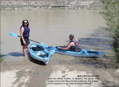 ?? NEWS PHOTO GILLIAN SLADE ?? Kevin and Wendy Kroeker, of Medicine Hat, launch their kayaks at Echo Dale Regional Park on Monday after a weekend of enjoyment on the water in various locations.