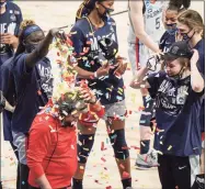  ?? Morry Gash / Associated Press ?? UConn coach Geno Auriemma is dunked with confetti after defeating Baylor in the Elite Eight round of the NCAA tournament on Monday.