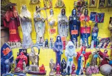  ?? ROBERTO E. ROSALES/JOURNAL ?? Statues of La Santa Muerte are displayed at the Masks y Mas art store in Albuquerqu­e. Bishops in the U.S. are finally denouncing the skeleton folk saint who is often connected to the illicit drug trade.