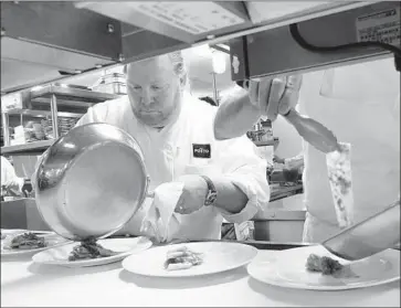  ?? Tina Fineberg Associated Press ?? MARIO BATALI plates a dish at Del Posto in 2006. He was reprimande­d after B&B Hospitalit­y Group investigat­ed a recent complaint by a restaurant employee about inappropri­ate behavior, a spokesman said.