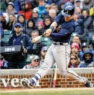  ?? JONATHAN DANIEL / GETTY IMAGES ?? Braves left fielder Preston Tucker hits a three-run home run in the fifth inning against the Cubs’ Yu Darvish on Friday. The Braves improved to 8-0 when they hit at least one home run.