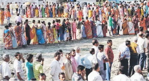  ??  ?? Voters line up to cast their votes outside a polling station during the first phase of general election in Alipurduar district in the eastern state of West Bengal, India.