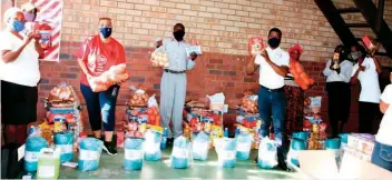  ??  ?? Ngelozi Community Projects receiving food parcels as part of the Covid-19 relief initiative