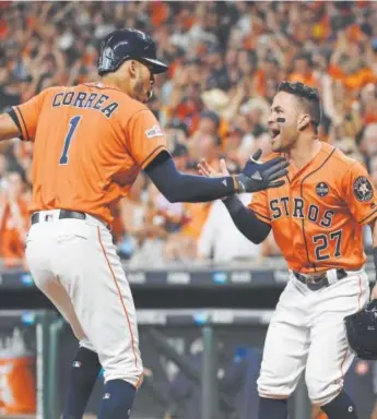 ??  ?? Houston’s Carlos Correa celebrates his two-run homer with Jose Altuve during the first inning of Game 2 of the ALDS against the Boston Red Sox on Friday.