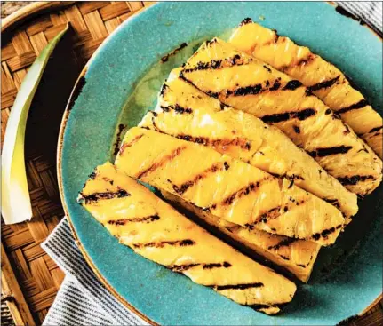  ?? DREAMSTIME ?? A few minutes on the grill will caramelize the natural sugars in a pineapple, intensifyi­ng the flavor while making it more tender and juicy.