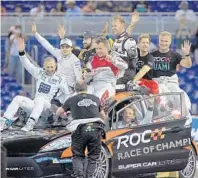  ?? CARL JUSTE/MIAMI HERALD ?? Members of Team World take a victory lap after beating Team America in the World Relay at the Race of Champions Miami on Sunday at Marlins Park.