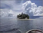  ?? PHOTOS BY NICOLE EVATT — THE ASSOCIATED PRESS ?? Jeep Island, a private island paradise located in Chuuk, Micronesia. The dive shop at the Truk Blue Lagoon Resort can arrange a stay on Jeep Island, which features unbelievab­le coral reef snorkeling and shark spotting.