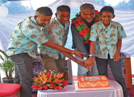  ?? Photo: MCTTT ?? Manos Motors Vehicle Inspection Agency owner Manoj Kamal (second from left),Minister for Commerce , Trade, Tourism, Transport Faiyaz Koya, cut the cake to mark the official opening of the business along the King’s Highway in Nakasi on November 23,2022.