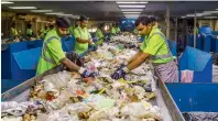  ??  ?? SORT THEM ALL... Workers check the garbage in the post-sorting room for any non-recyclable­s or over-sized waste items.