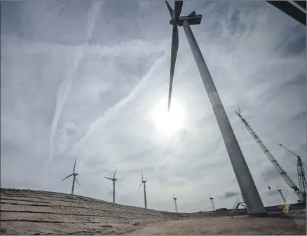  ?? Brian van der Brug Los Angeles Times ?? WIND TURBINES near State Route 58 generate electricit­y for providers including Clean Power Alliance, a new government-run entity that next month will replace Edison as the power source for more than 1 million Southland homes and businesses.