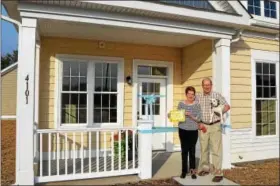  ?? SUBMITTED PHOTO ?? Ernie and Virginia Conrad, with their dog Roux, moved into their new home at The Meadows on June 25.