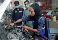  ?? AFP ?? Motor mechanic Uzma Nawaz fixes a car at an auto workshop in Multan. —