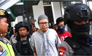  ?? — Reuters photo ?? A chief of Jemaah Ansharut Daulah (JAD) arrives for his trial at South Jakarta court in Indonesia.