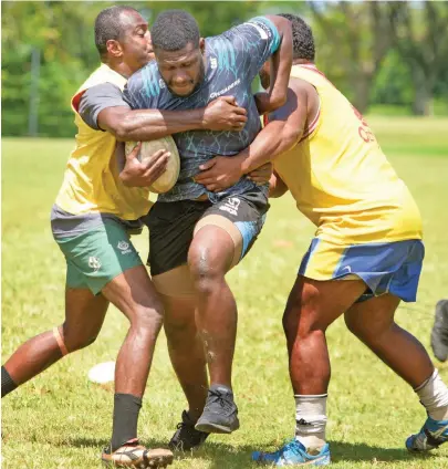  ?? Photo: Ronald Kumar. ?? Tailevu first five-eighth Seru Vaniqi (with ball) bursts through two tacklers during training at the University of the South Pacific (USP) ground, Suva, on April 7, 2021.