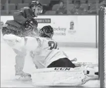  ?? PHOTOS BY NATHAN DENETTE, THE CANADIAN PRESS ?? Canada’s Brett Howden got the scoring going fast, beating Swiss goalie Philip Wuthrich 48 seconds into the game, above, then celebratin­g before a snowstorm-reduced crowd of 5,533. Howden added two assists.