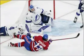  ?? PAUL CHIASSON — THE CANADIAN PRESS VIA AP ?? Montreal Canadiens right wing Josh Anderson (17) scores past Tampa Bay Lightning goaltender Andrei Vasilevski­y (88) as Lightning defenseman Jan Rutta (44) defends during overtime of Game 4of the NHL hockey Stanley Cup final in Montreal, Monday, July 5, 2021.