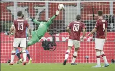  ?? PHOTO/LUCA BRUNO ?? AC Milan’s goalkeeper Gianluigi Donnarumma makes a save from Inter Milan during a Serie A soccer match between AC Milan and Inter Milan, at the San Siro stadium in Milan, Italy, on Saturday. AP