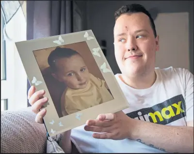  ??  ?? Darren Goudie with a picture of his brother Brandon who became ill at the age of four