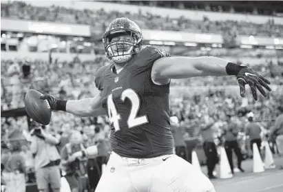  ?? NICK WASS/ASSOCIATED PRESS ?? The Ravens’ Patrick Ricard spikes the ball after catching a touchdown pass against the Rams. Ricard, who plays fullback and defensive tackle, did not receive a single poor grade from coach John Harbaugh for his performanc­e Thursday night.