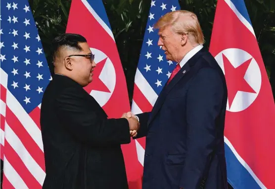  ?? Picture: AFP ?? North Korea’s leader Kim Jong-un shakes hands with US President Donald Trump at the start of their historic summit in Singapore yesterday.