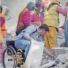  ??  ?? Eduardo Zarate, a 26-year-old man with a spinal cord injury which has left him confined to a wheelchair, went to Mexico City's Del Valle neighborho­od to help the clean-up