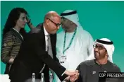  ?? RAFIQ MAQBOOL / AP ?? COP28 President Sultan al-Jaber (right) greets U.N. Climate Chief Simon Stiell at the COP28 U.N. Climate Summit, in Dubai, UAE, on Monday.