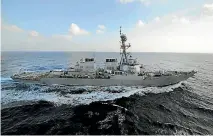  ?? PHOTO: REUTERS ?? The guided missile destroyer USS Mahan fired three warning shots at Iranian patrol boats which closed within less than a kilometre of it near the Strait of Hormuz.