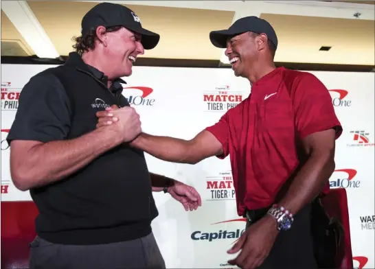  ?? Richard Brian ?? Las Vegas Review-journal @vegasphoto­graph Phil Mickelson, left, and Tiger Woods share a laugh during a news conference Tuesday for The Match, which is scheduled for Friday at Shadow Creek Golf Course.