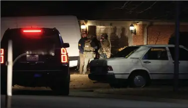  ?? (Arkansas Democrat-Gazette/Thomas Metthe) ?? FBI agents carry out a federal search warrant Thursday evening at the Conway home of Peter Francis Stager. Stager was arrested in the beating a police officer with an American flag during the U.S. Capitol riot Jan. 6.