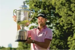  ?? ERIC GAY/AP ?? Justin Thomas holds the Wanamaker Trophy after winning the PGA Championsh­ip a playoff against Will Zalatoris at Southern Hills Country Club Sunday in Tulsa, Oklahoma. Thomas rallied from a seven-shot deficit and then saved his most exquisite shot-making for a threehole playoff.