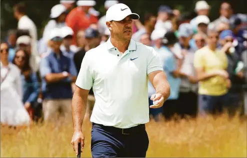  ?? Jared C. Tilton / Getty Images ?? Brooks Koepka waves on the second green during the third round of the 122nd U.S. Open Championsh­ip at The Country Club on Saturday in Brookline, Mass. Koepka, who will join the LIV Golf tour is still going to play the Travelers Championsh­ip this week.